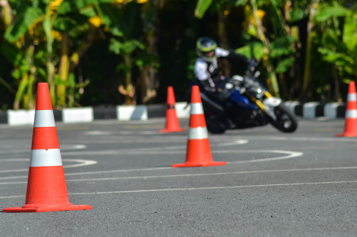 Motorcycle driving over coins - have good credit