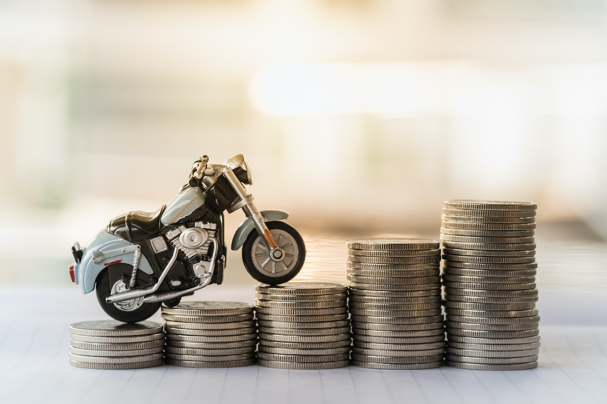 Motorcycle driving over coins - have good credit