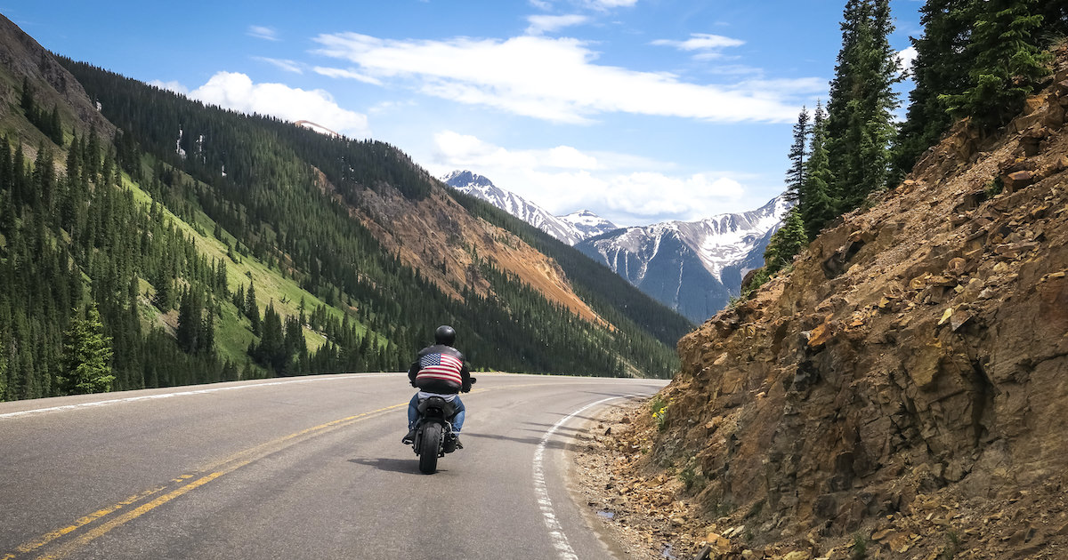 Motorcyclist drives through Ouray, Colorado - insuring