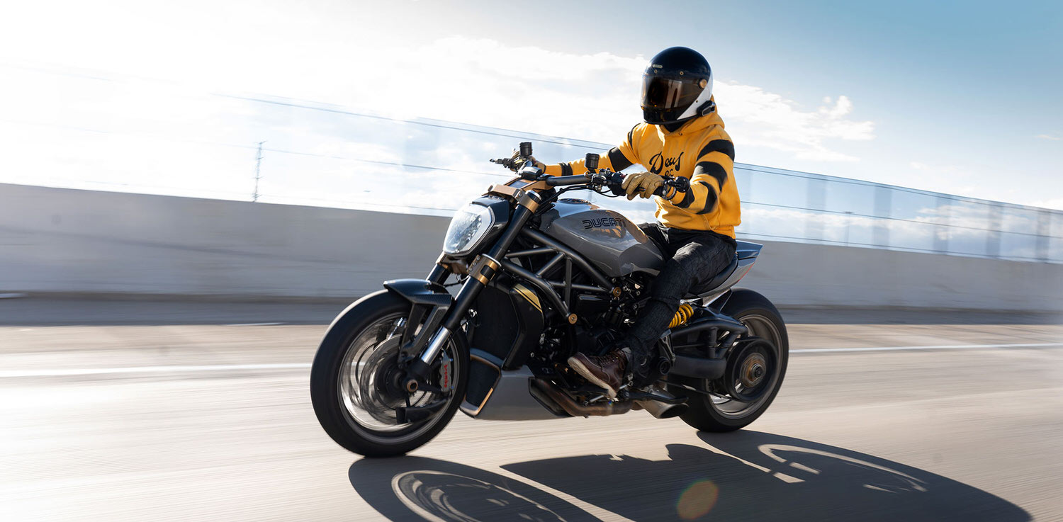 Man riding Ducati motorcycle with helmet