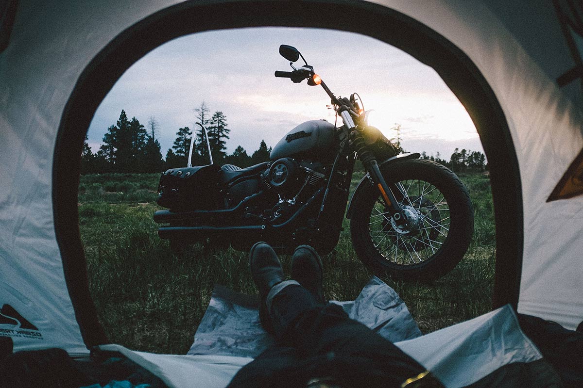 Motorcycle as seen from the inside of a camping tent