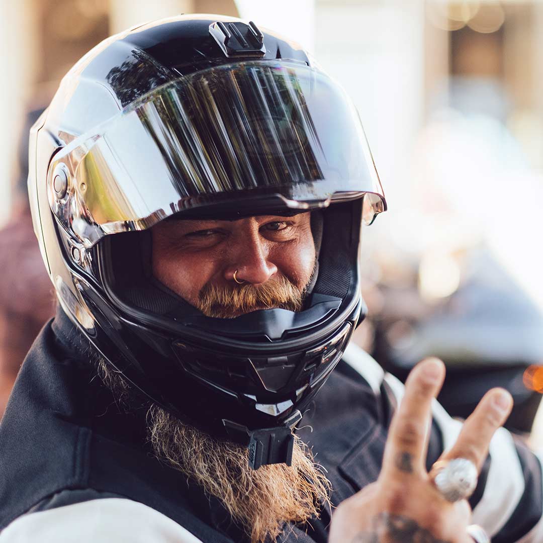 Dumptruck wearing motorcycle helmet giving peace sign