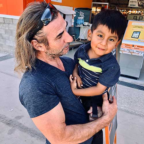 Neale Bayly holding child  | colorado motorcycle lawyers motorcycle advocates
