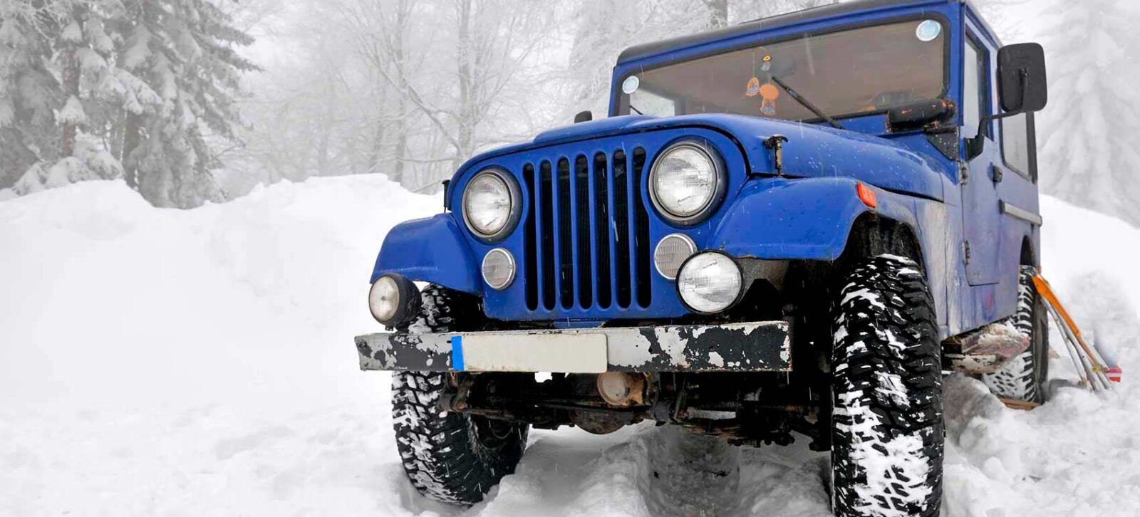 Jeep in winter snow overlanding adventure