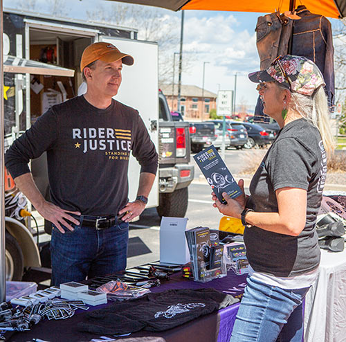 Scott O'Sullivan, personal injury attorney, talking with a female motorcyclist