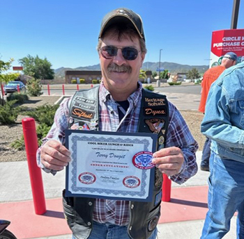 Terry Douget receives his certificate for riding 1000 miles in 24 hours.