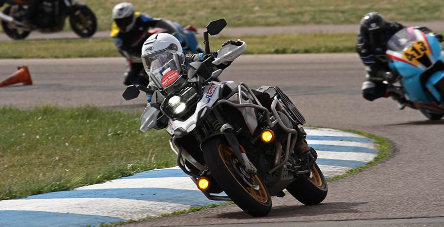 Kandi Spangler practicing rider her motorcycle on a race track