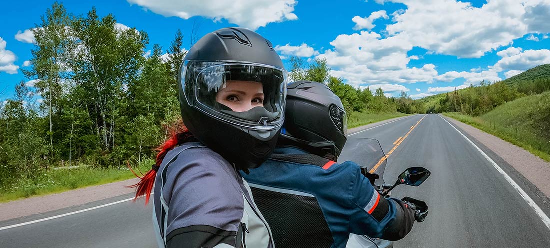 Woman riding on the back of a motorcycle
