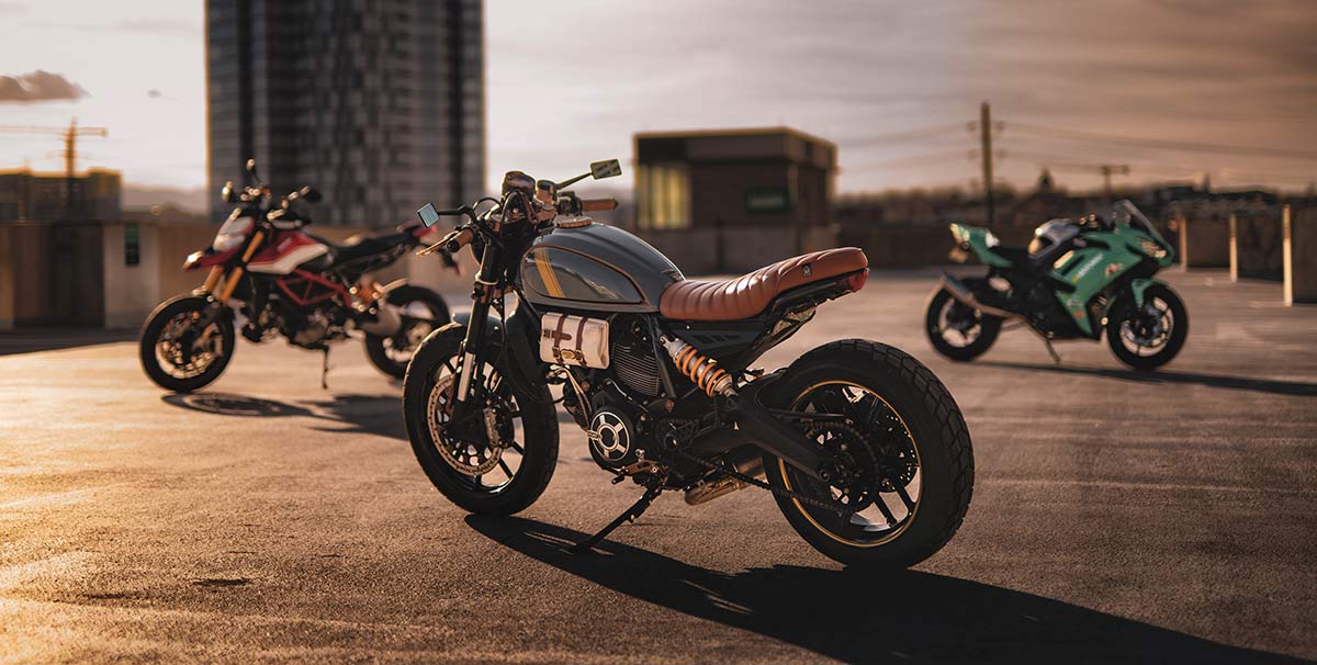Three motorcycles of different styles including Ducati motorcycles.
