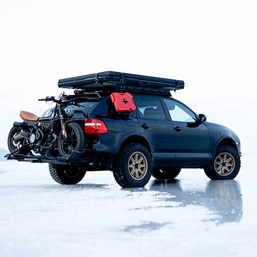 SUV with motorcycle on a rear lift