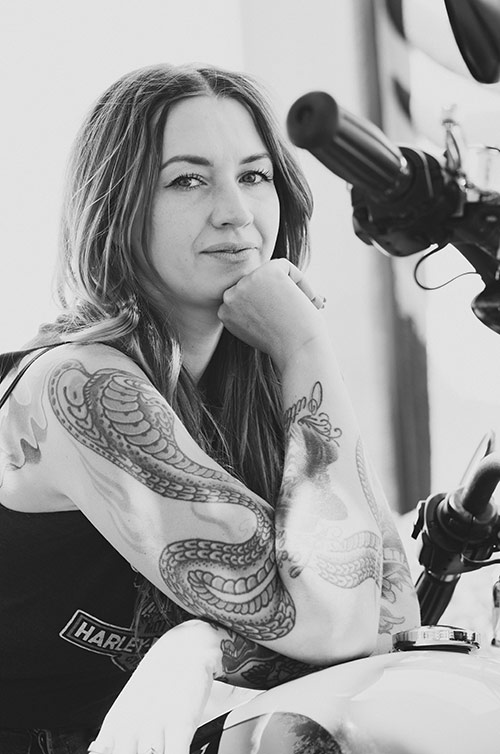 Rachel with tattoos and her motorcycle.